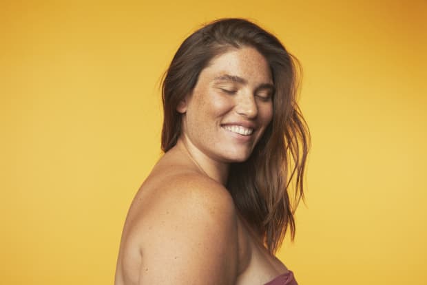 Photo of woman smiling with eyes closed