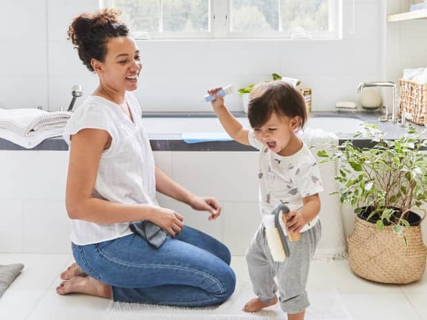 Photo of woman and child in front of bathtub