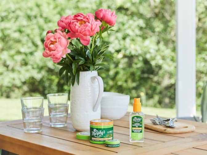 Photo of Murphy's Naturals insect repellent spray and balm on table outside