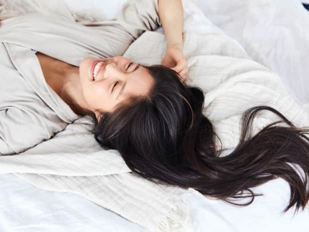 Woman lying down on bed