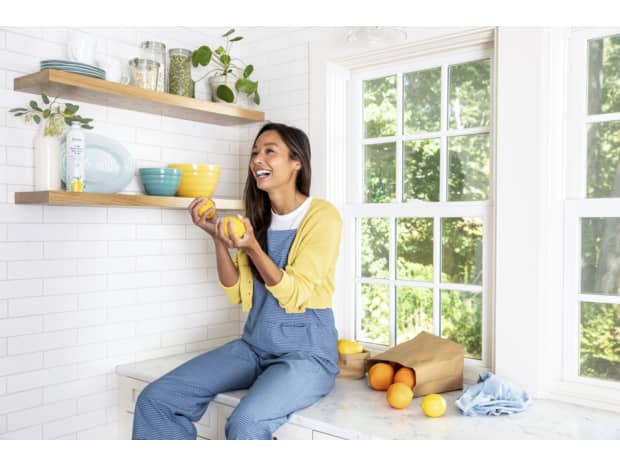 laundry woman lemons washing machine shelf