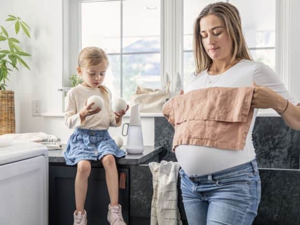 Woman and child folding laundry