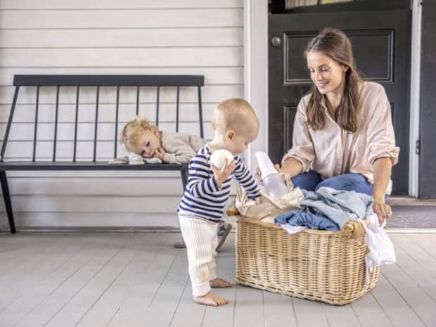 Woman and children with laundry basket