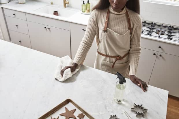 Woman wiping down counter