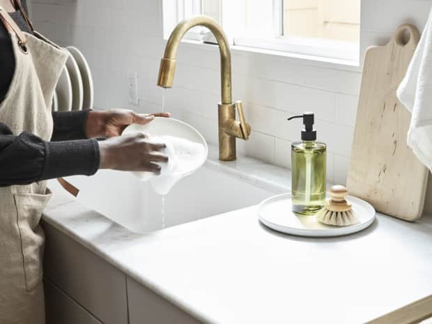 Picture of person at sink washing a dish