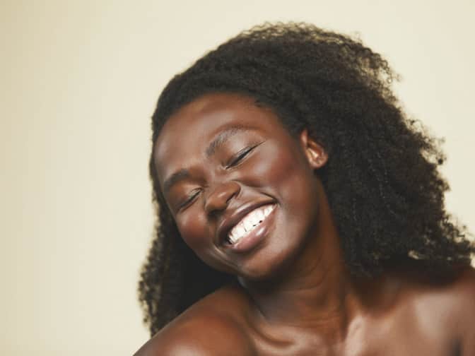 Portrait of woman smiling with eyes closed