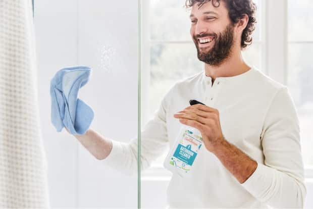 Person cleaning shower head