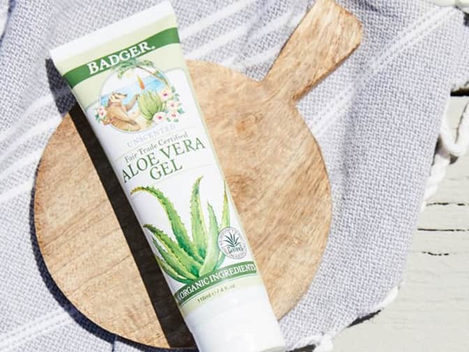 Image of Badger Aloe Vera Gel tube sitting on wooden cutting board on top of grey towel