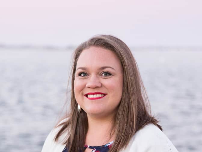 Image of woman standing in front of water