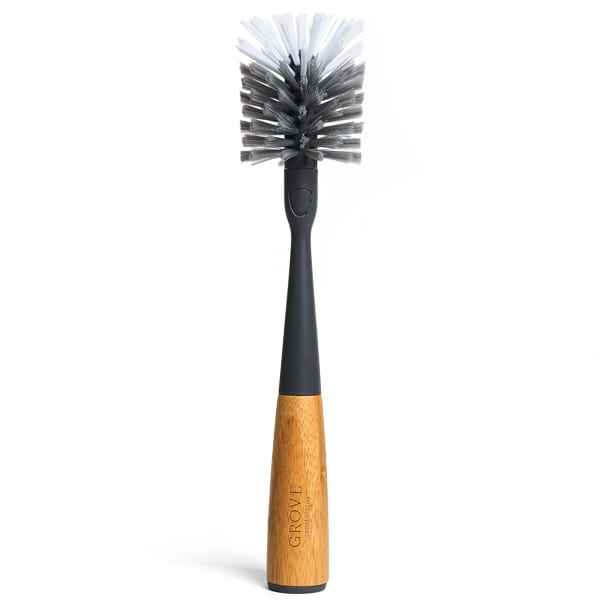 The Replaceable Head Bottle Brush by Grove Co. has a black handle with a wooden grip and dense bristles for cleaning baby bottles and narrow containers. Its sleek design, engraved with Grove, is also ideal for reusable water bottles.