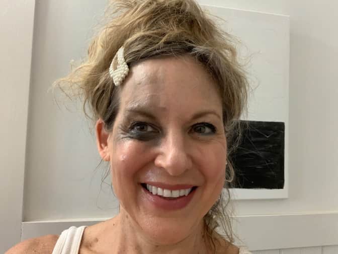 Photo of woman with makeup remnants on left of face
