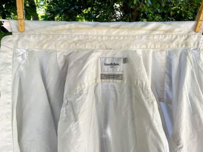 Photo of dirty white shirt hanging on clothesline