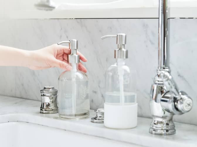 Grove hand and dish vessel on the side of a sink