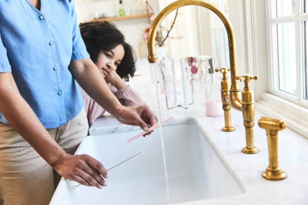 Woman and child at sink