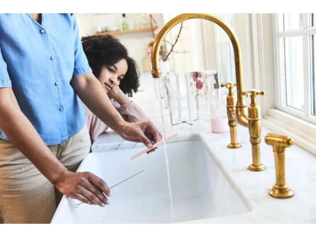 Woman and child at sink