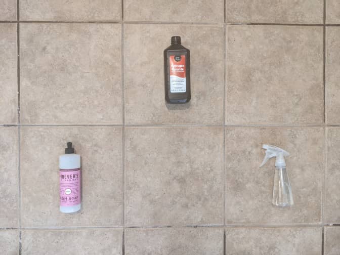 Photo of three different cleaners placed in three different tiles that have been cleaned