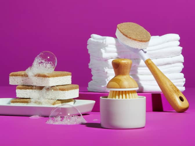 Brush and bar soap being used at a kitchen sink