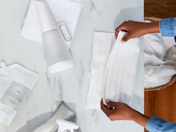 Person folding their clean laundry after cleaning it by hand.