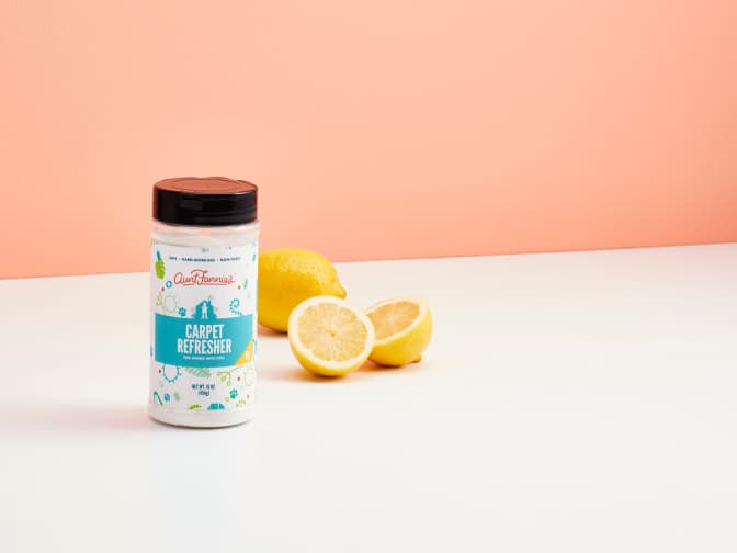 Image of Aunt Fannie's Carpet Refresher bottle on floor next to lemons