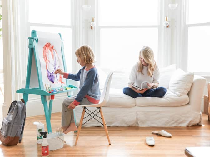 Image of a mother and a child in a living room. 
