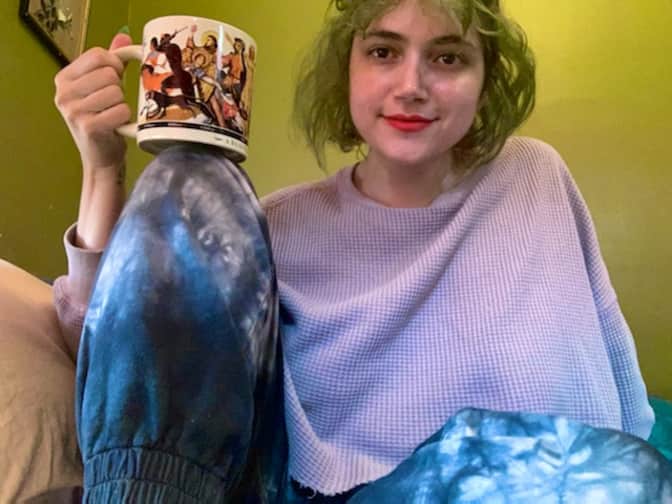 Photo of woman in bed holding mug Mackenzie Sanford Grove writer author