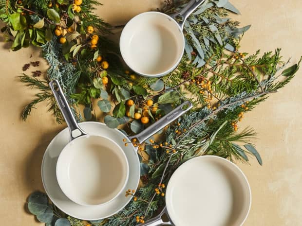 A collection of pots and pans arranged artfully with some beautiful greenery