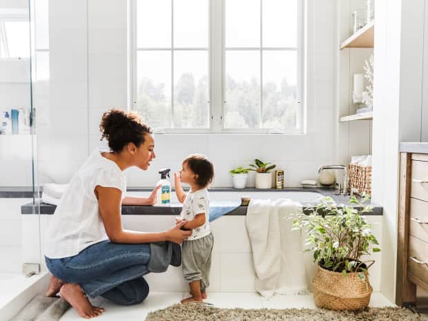 mom and child cleaning bathtub 