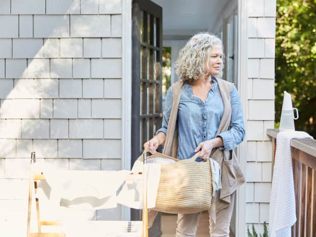 woman holding laundry basket outside