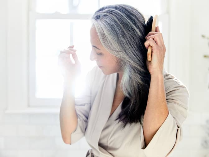 Image of a woman brushing her hair