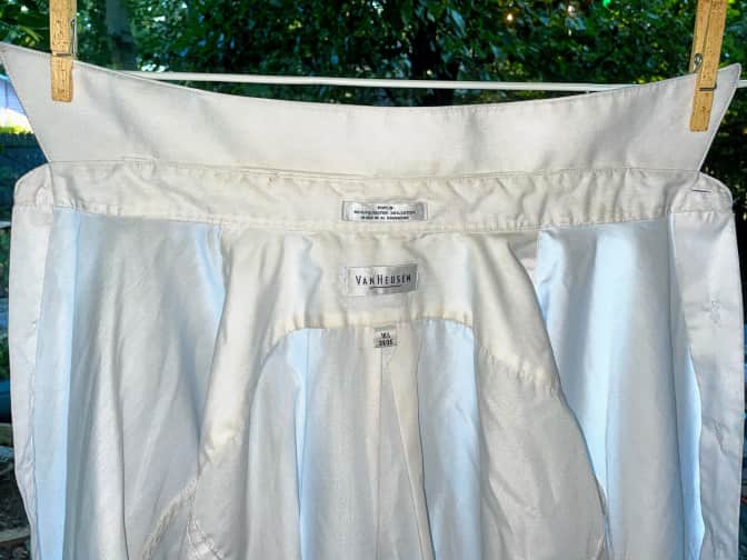 Photo of clean white shirt hanging on clothesline