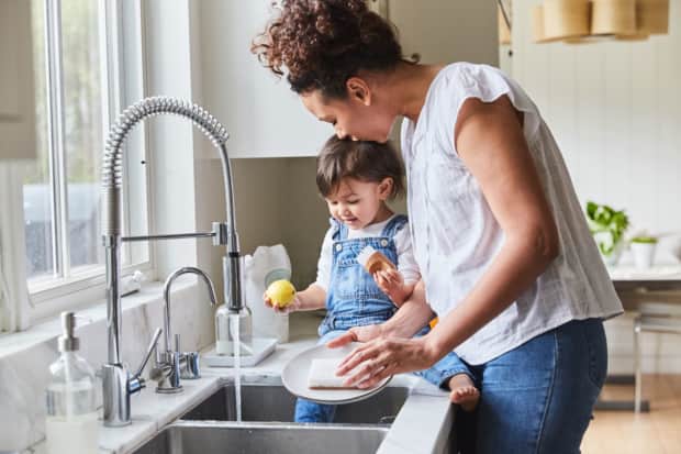 Woman and child doing dishes
