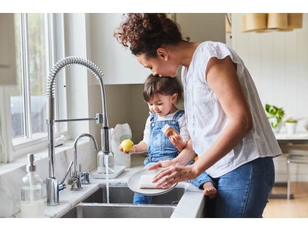 Woman and child doing dishes