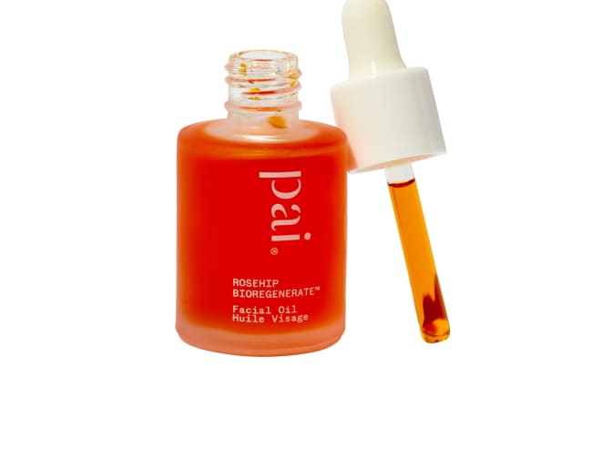 Pai Rosehip Oil bottle with dropper leaning up against it