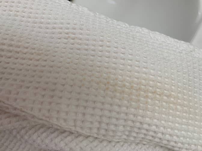 Close up of white robe with light stain