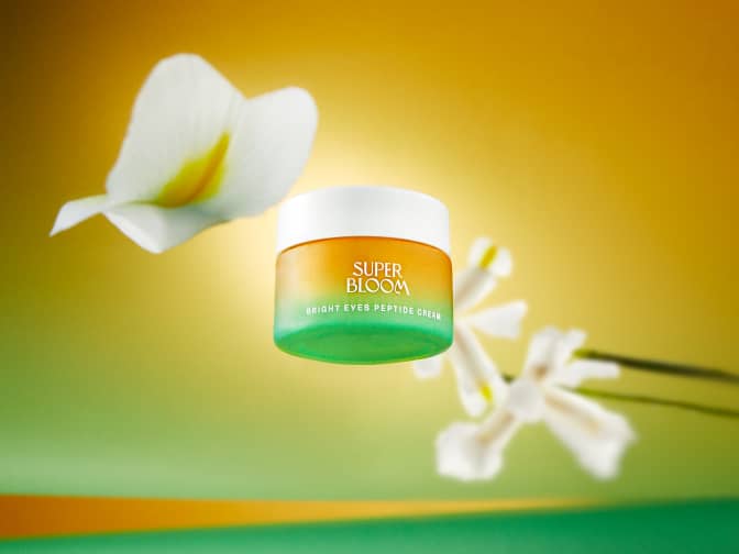 Image of Superbloom product jar floating with white flowers in background