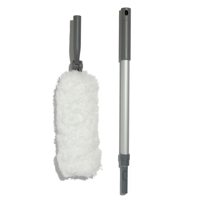 On a white background, the Grove Co. Compact Duster is displayed with a fluffy white duster, gray universal handle, and an extendable silver pole with a gray grip, highlighting its replaceable duster head and detachable parts.