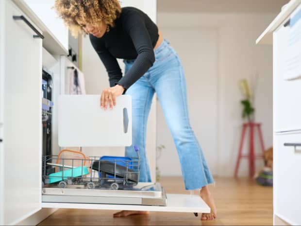 woman loading dishwasher