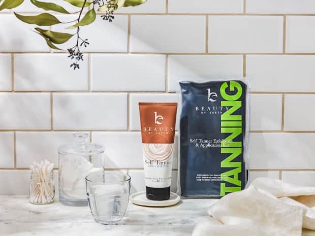 Beauty by Earth self tanner kit displayed on a marble counter