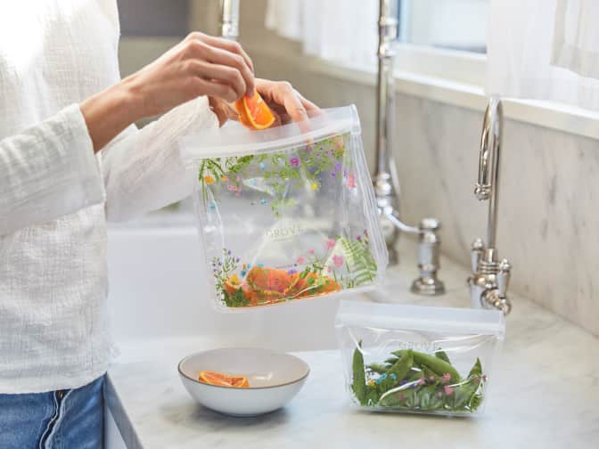 Woman putting snacks into Grove reusable storage bags