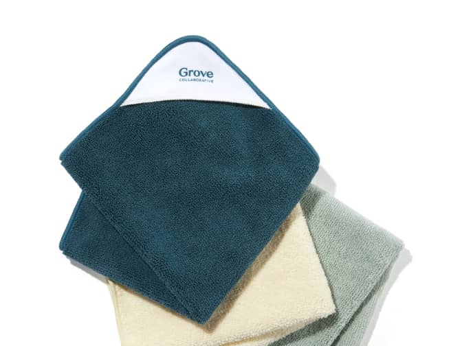 Three microfiber cloths in dark green, cream, and gray